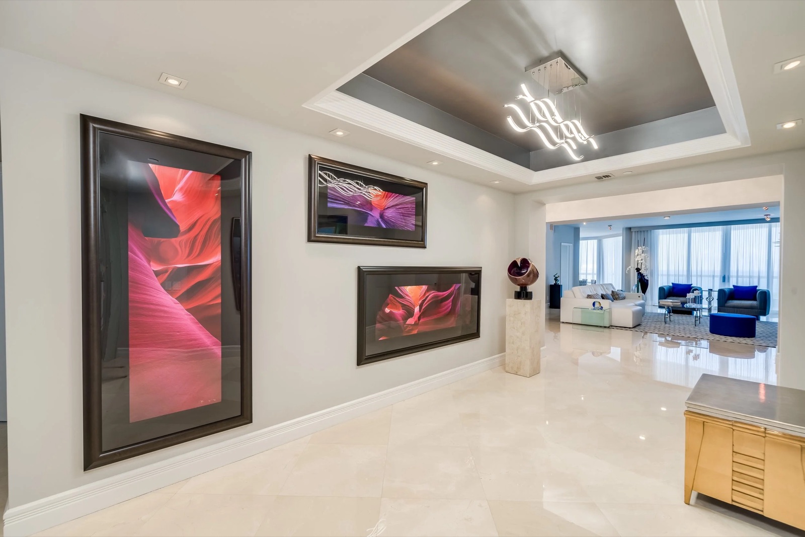 Oceanfront penthouse interior with gallery lighting and marble floors by The Painted View Interiors, Fort Lauderdale